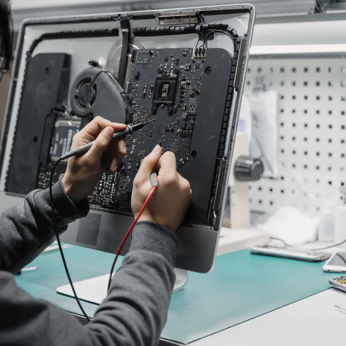 Technician working on a real computer motherboard