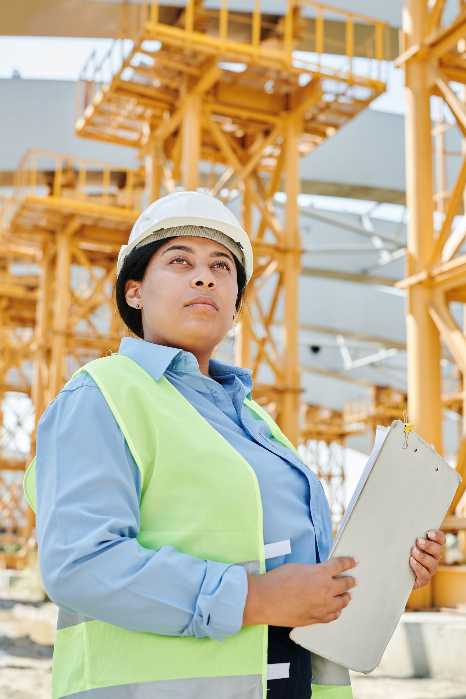 Engineer wearing a hard hat and high-visibility vest at a worksite