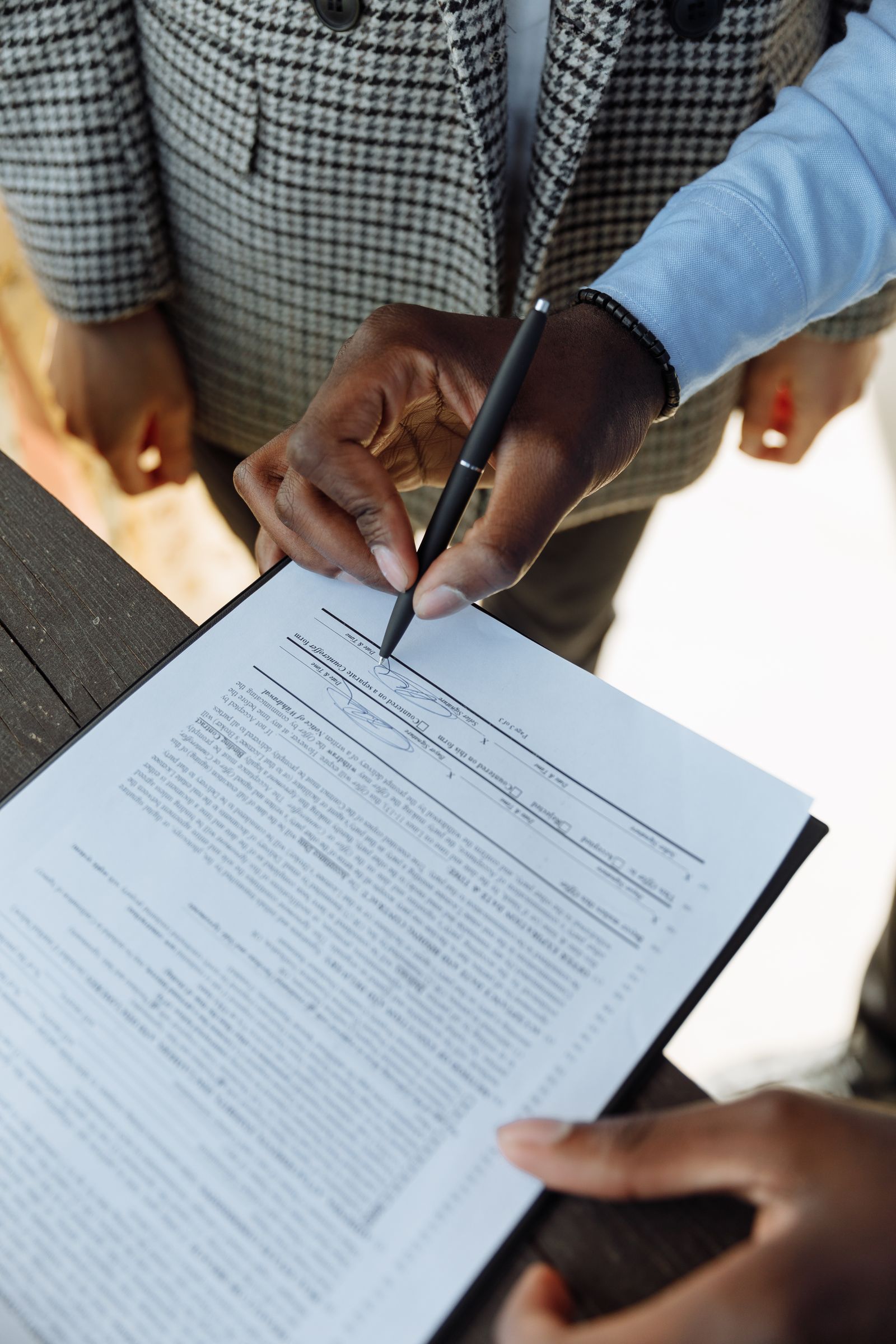Hands signing a company agreement