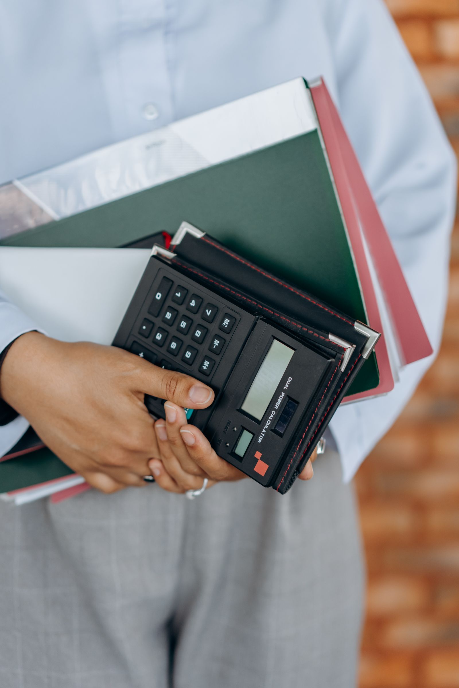 Payroll administration illustrated by a calculator and office files