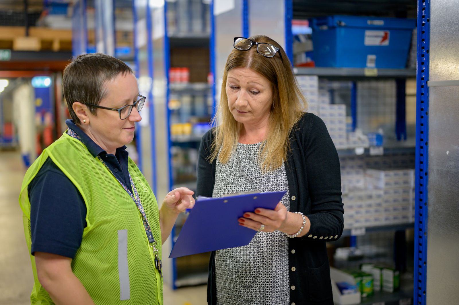 Warehouse colleagues reviewing an inventory checklist