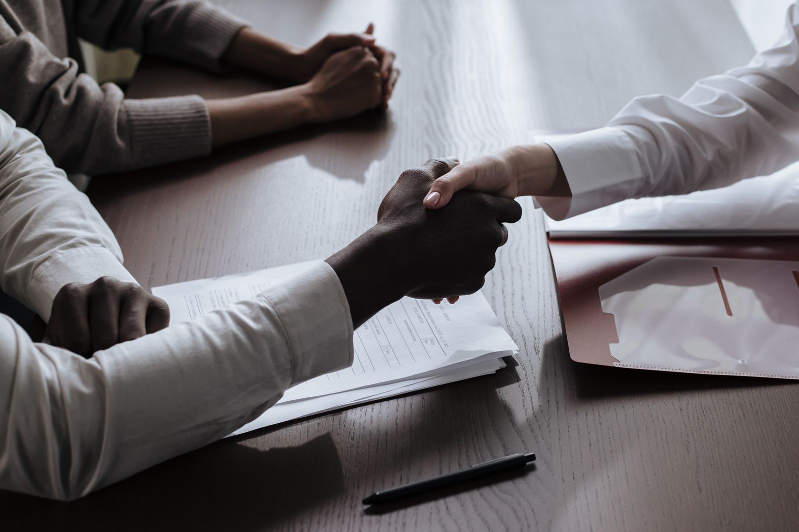 Business agreement over a meeting table