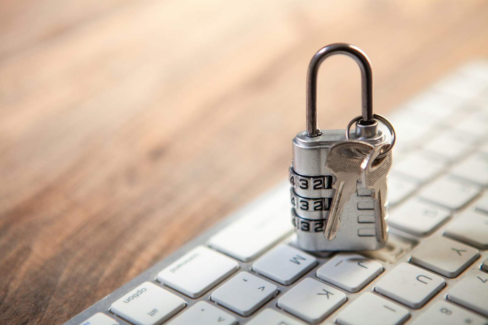 Padlock and keys resting on a real computer keyboard